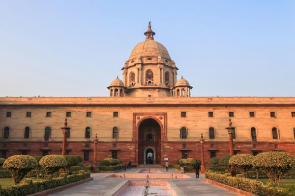 Explore the iconic Rashtrapati Bhavan with its historical architecture in sunny Delhi.